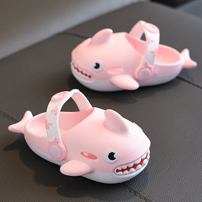 Close-up of black cartoon shark slippers for kids, showcasing the anti-slip sole for safety.