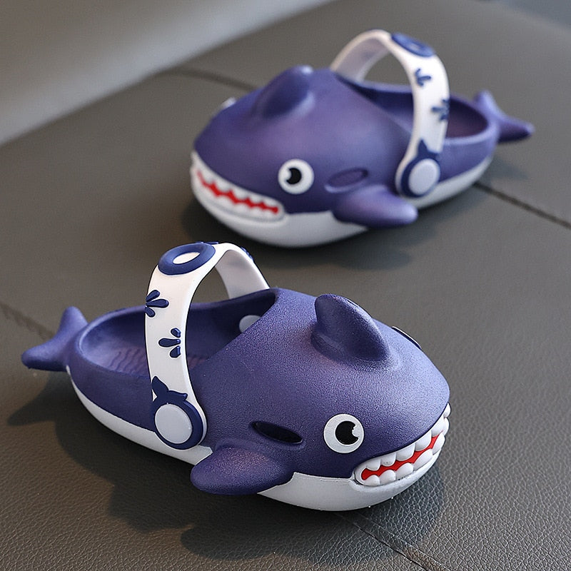 Vibrant blue children's shark slippers, highlighting the comfortable and secure fit for active play.