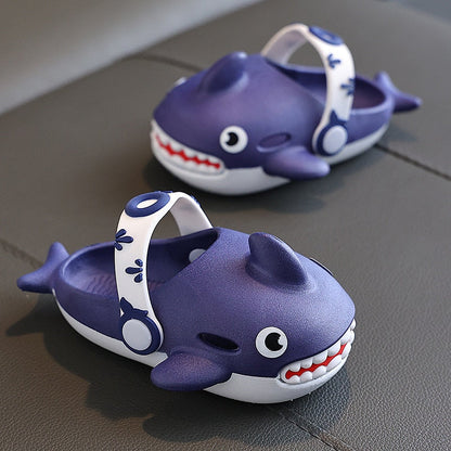 Vibrant blue children's shark slippers, highlighting the comfortable and secure fit for active play.