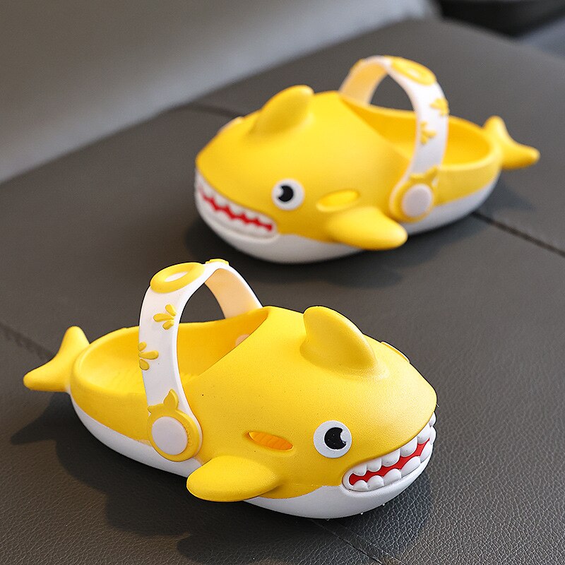 Bright yellow kids' shark slippers, featuring a lightweight design and easy-care properties.