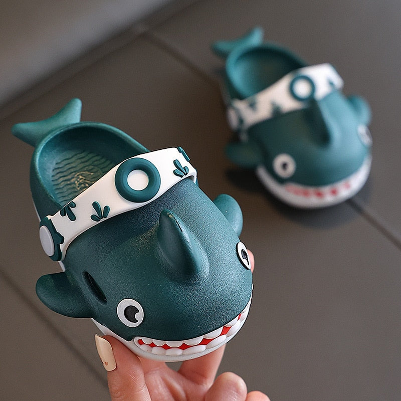 Toddler's black shark slippers with an anti-slip sole for enhanced stability during play.
