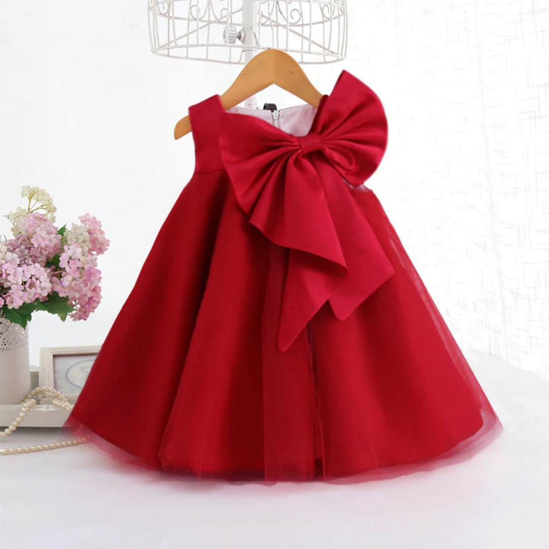 Elegant toddler girls' sleeveless party dress with a large bow and delicate mesh skirt.