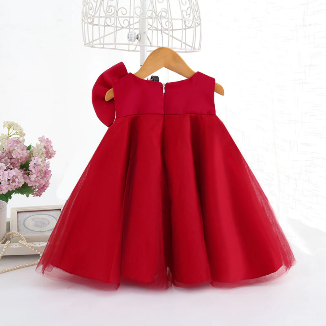 Close-up of a big bow on a girls' sleeveless cocktail dress, ready for any celebration.