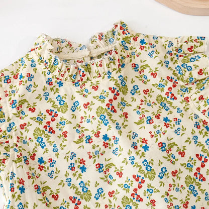 Toddler girl in a cute floral print cotton top and skirt set, ideal for warm weather playwear.
