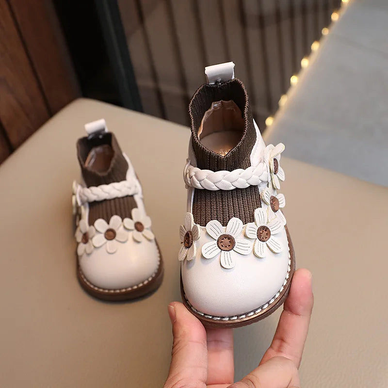 Cute infant girls' soft sole shoes with a colorful floral design.