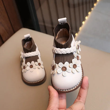 Cute infant girls' soft sole shoes with a colorful floral design.