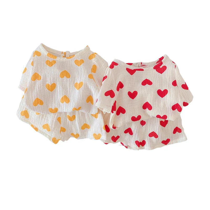 Adorable girls' heart print cotton summer outfit, perfect for active toddlers. Breathable playwear set.