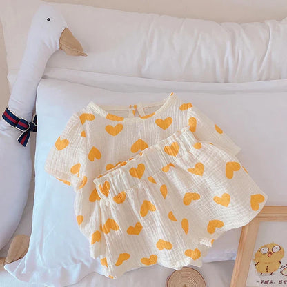 Full view of a girls' heart print cotton summer outfit, great for everyday toddler wear. Kids fashion.