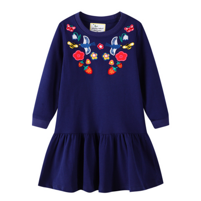 Cute toddler girls' knee-length dress featuring vibrant embroidery patches on soft long sleeves.