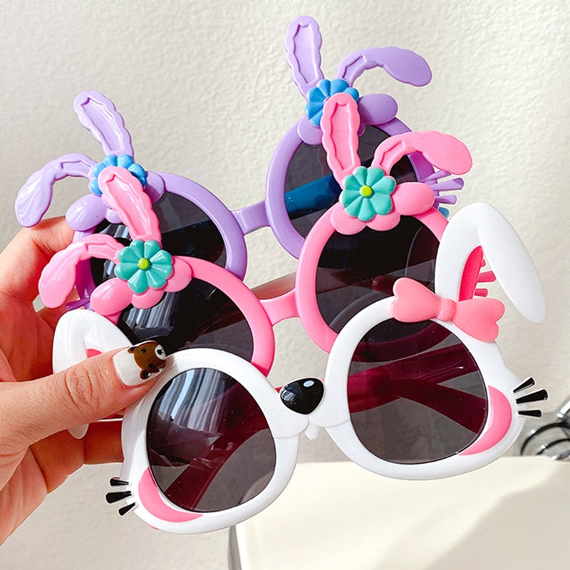 Adorable girls' pink rabbit cartoon sunglasses offering UV protection, perfect for outdoor fun.