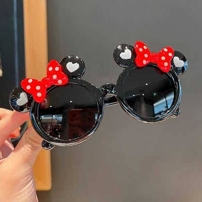 Close-up of girls' rabbit cartoon sunglasses, showcasing cute design and UV protective lenses.