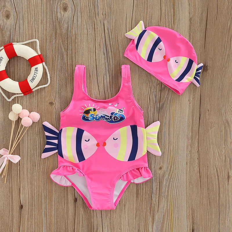 Toddler girl in a vibrant fish print polyester swimsuit and swim cap, ready for beach or pool play
