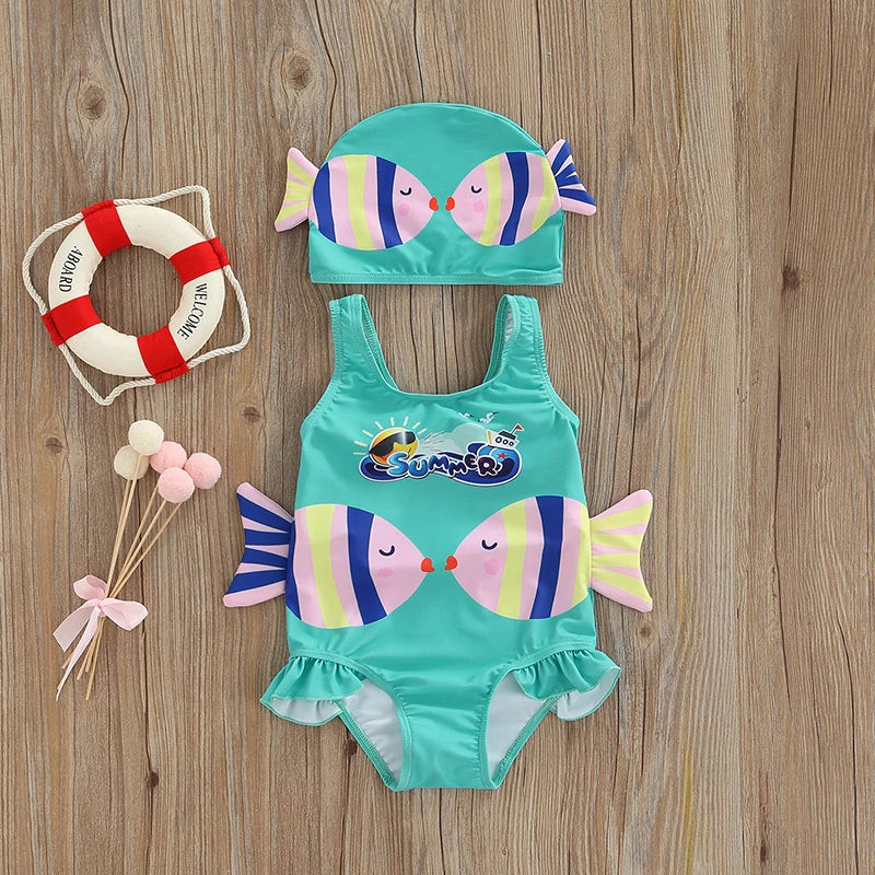 Close-up of a pink girls' swimsuit with playful fish print, paired with a coordinating swim cap