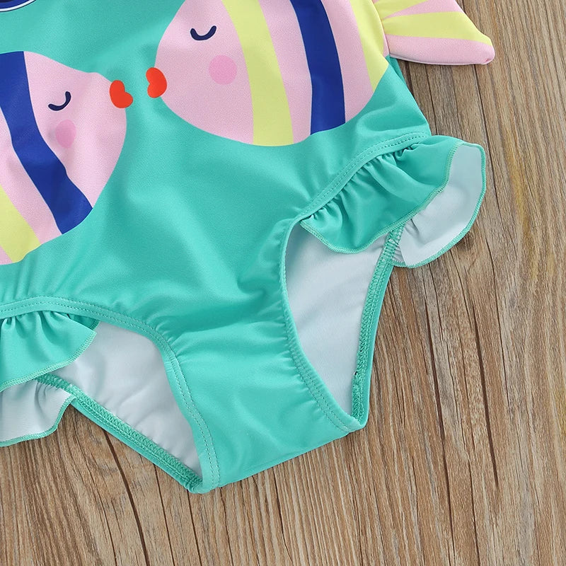 Front view of a girls' fish print bathing suit with a secure fit and a matching swim cap for toddlers