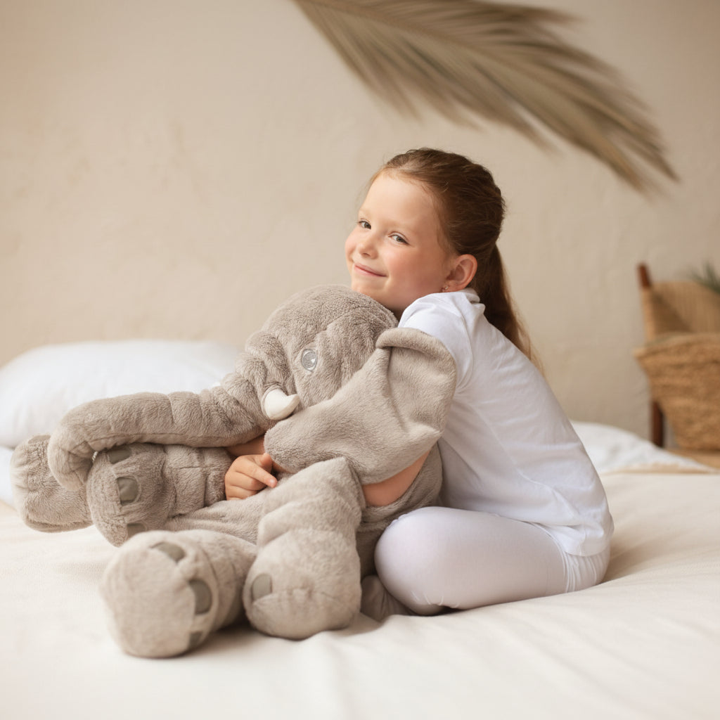 Soft grey elephant plushie, a perfect kids gift. This adorable stuffed animal doubles as a comfy cuddle pillow.