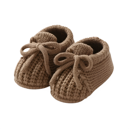 Comfortable gray knitted infant booties, soft sole shoes for a cozy baby first outfit.