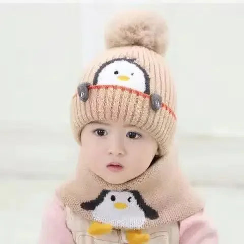 Soft knit penguin-themed winter hat with ear flaps and matching warm scarf for children