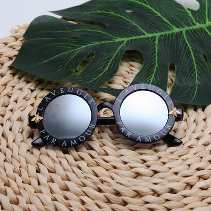 Stylish kids' round frame sunglasses in a multi-color design, perfect for UV protection and fun.