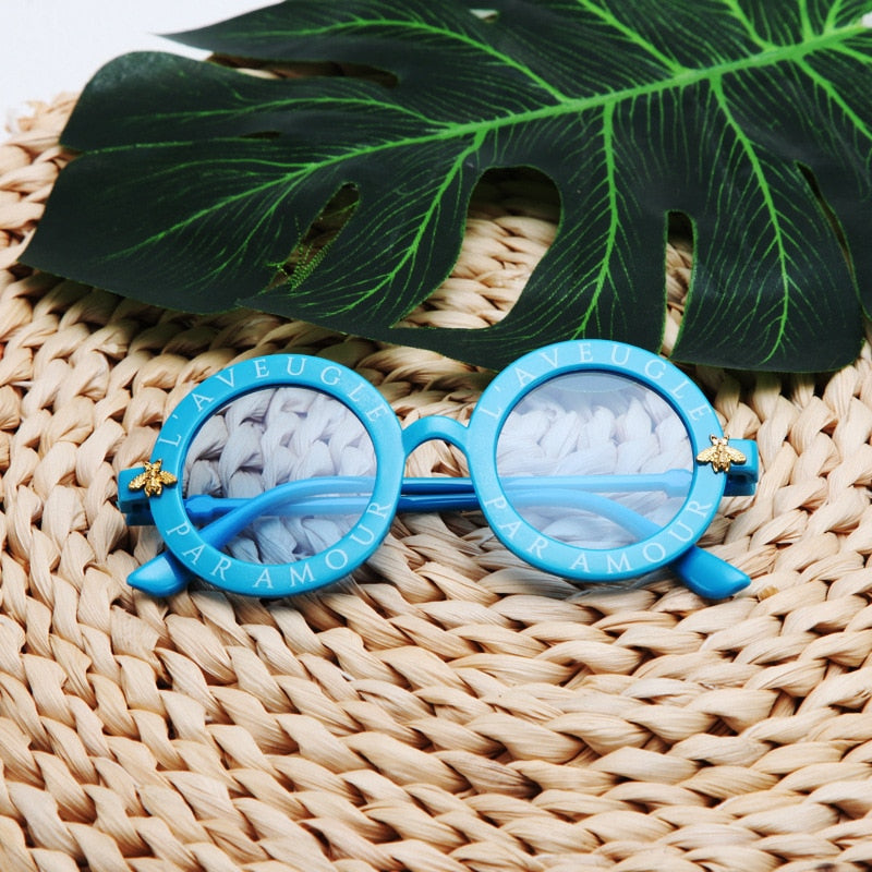 Infant's round frame UV protection sunglasses, lightweight and comfortable for sensitive eyes.
