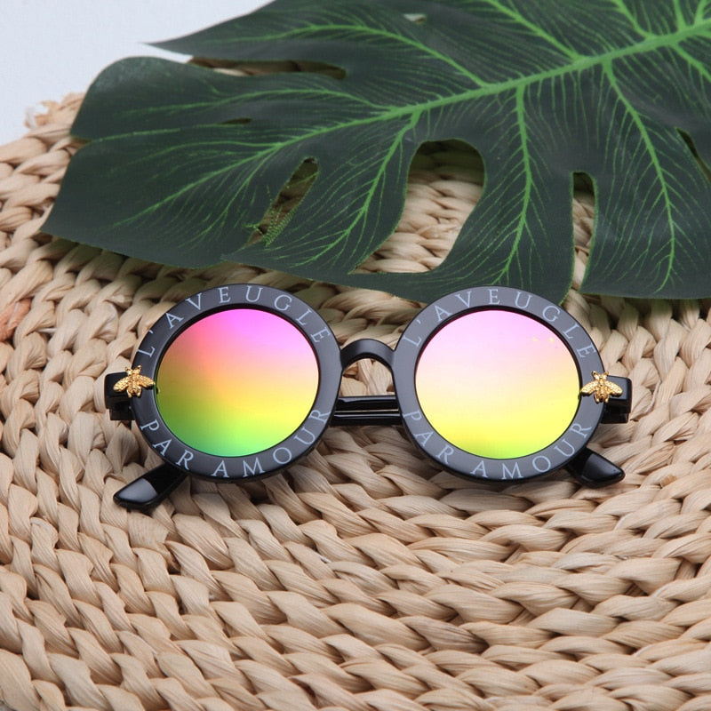 Toddler's round frame sunglasses with 100% UV protection, essential for outdoor toddler play.
