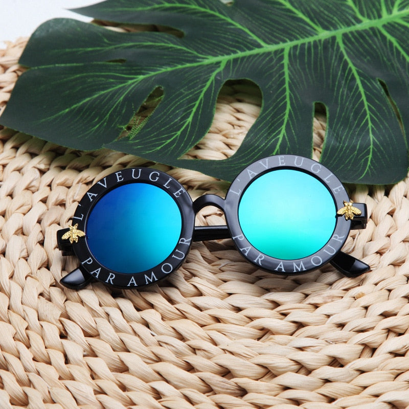 Boys' cool round frame sunglasses with advanced UV protection, great for outdoor adventures.