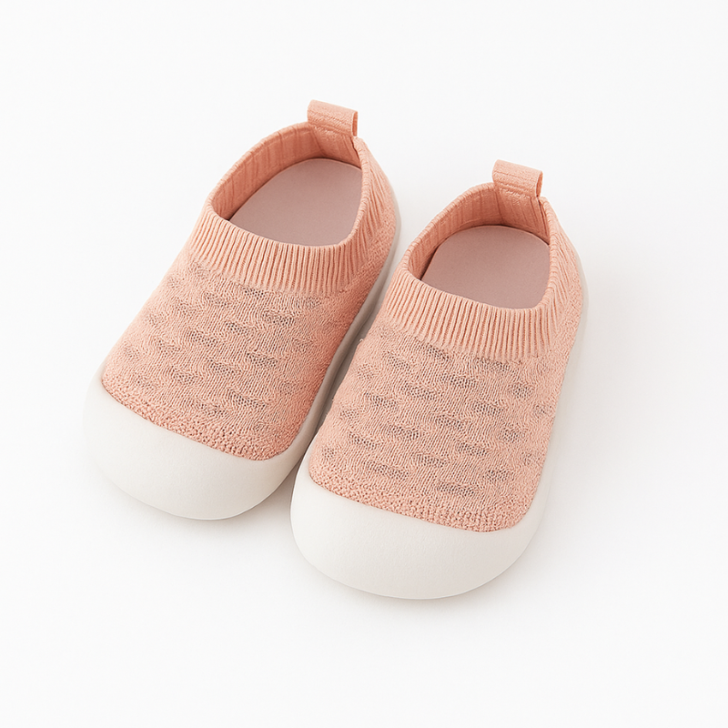 Baby boy in blue knit slip-on shoes, great for early walking stages.