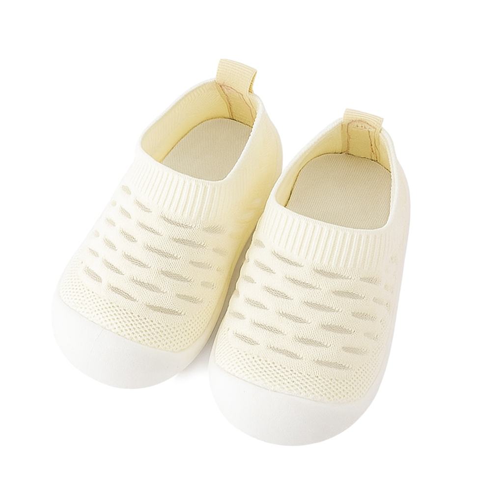 Pair of gender-neutral knit first walking shoes offering a barefoot feel.