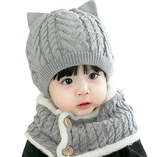 Adorable knitted baby cat hat and scarf set in pink, perfect for winter warmth for infants and toddlers.
