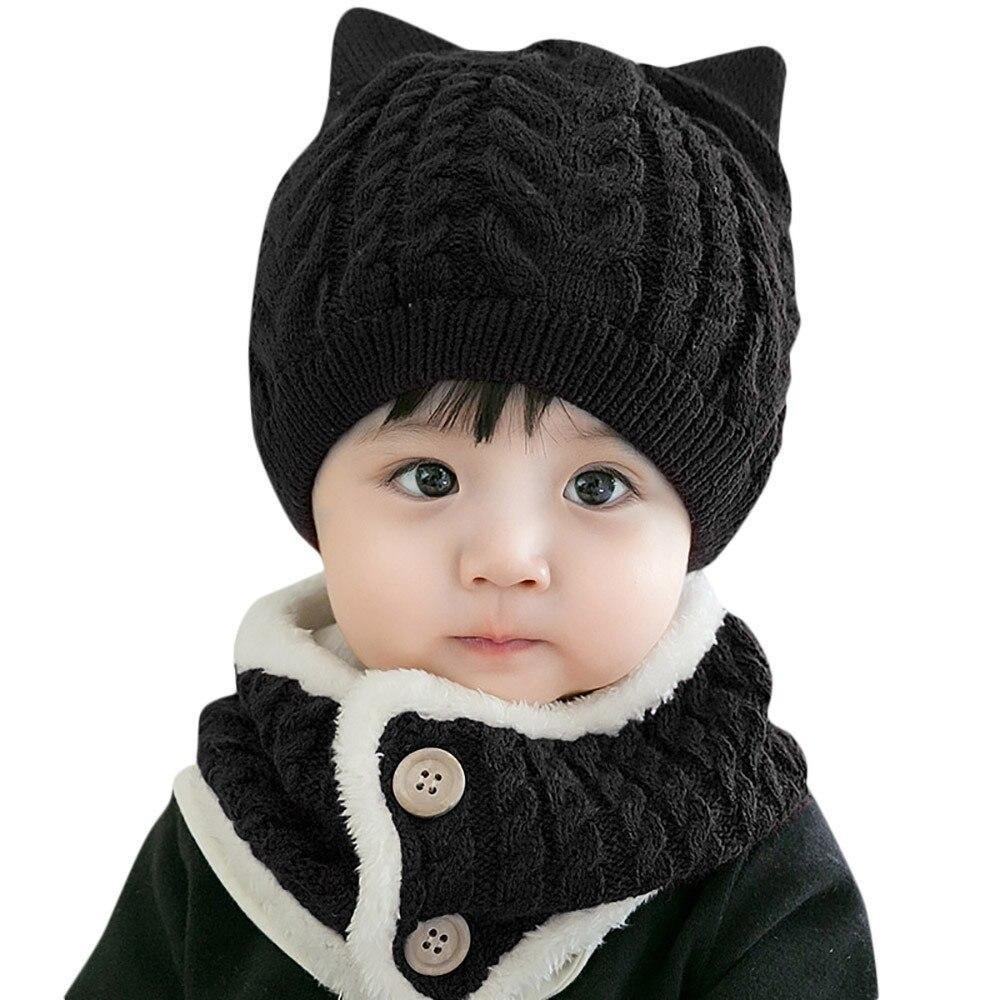 Soft blue knitted baby cat hat and scarf set with ear details, providing cozy warmth for winter.