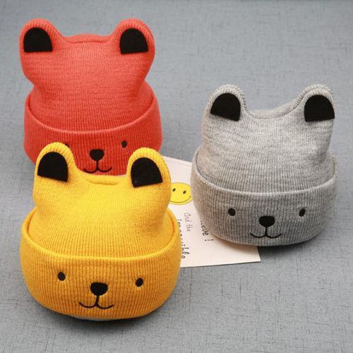 Close-up of soft knitted bear cub hat, showcasing texture; a charming kids winter accessory.