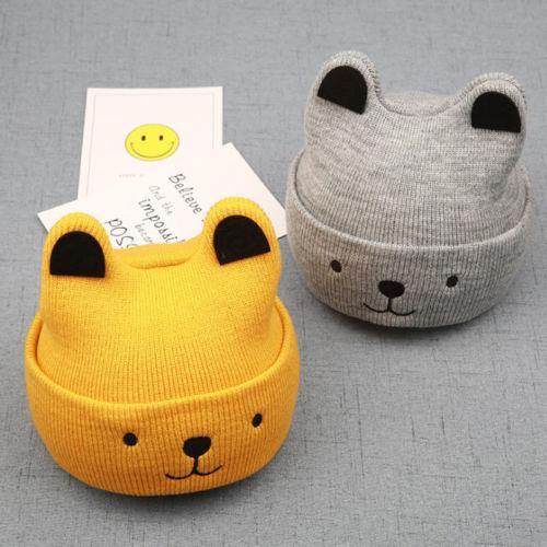 Knitted bear cub hat in natural cotton, a comfortable and stylish unisex kids accessory.