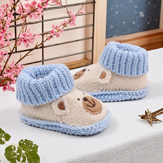 Adorable knitted non-slip baby booties in a neutral color, perfect for newborns and infants.