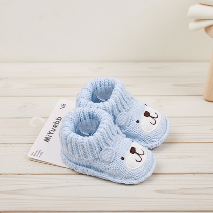 Practical knitted slippers for babies, featuring a reinforced non-slip sole for safe play.