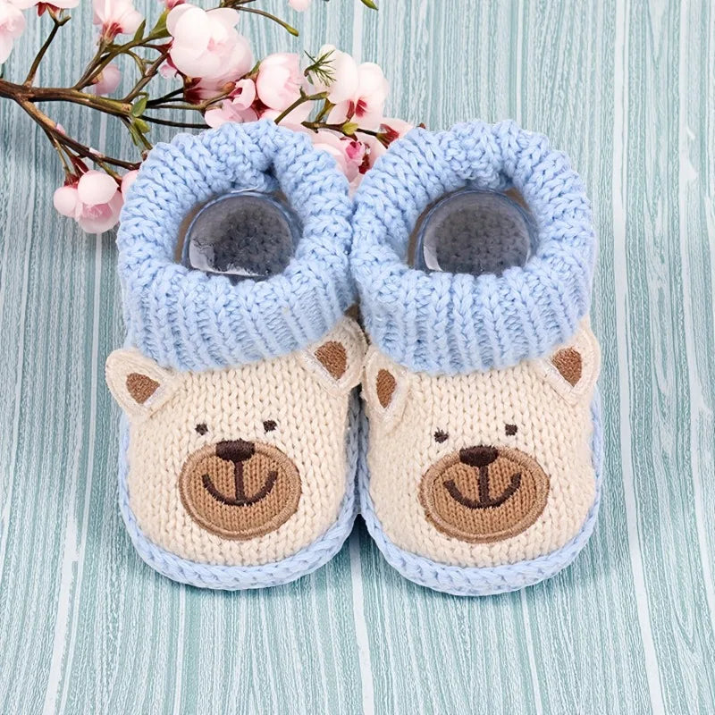 Charming baby booties with a gentle animal print, offering warmth and non-slip safety.