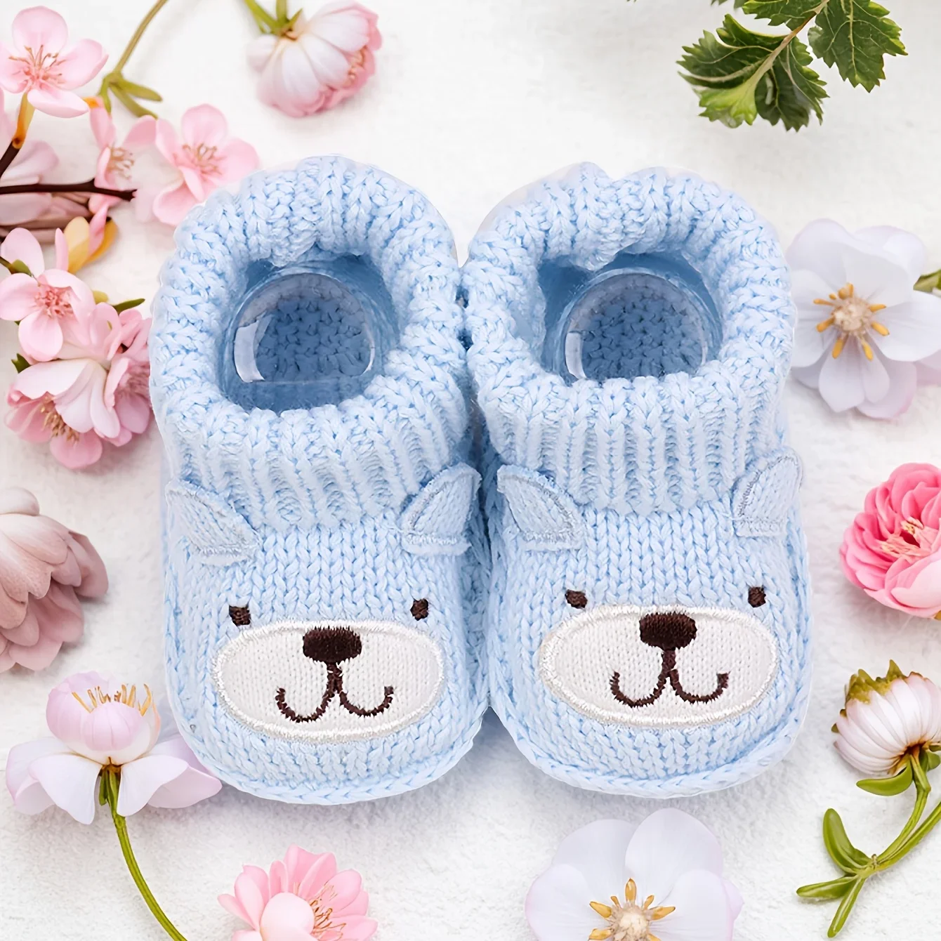 Cozy knitted infant slippers, designed for comfort and featuring a non-slip sole.