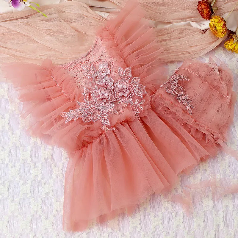 Fashionable baby girl romper set featuring intricate lace and mesh detail, suitable for newborns.