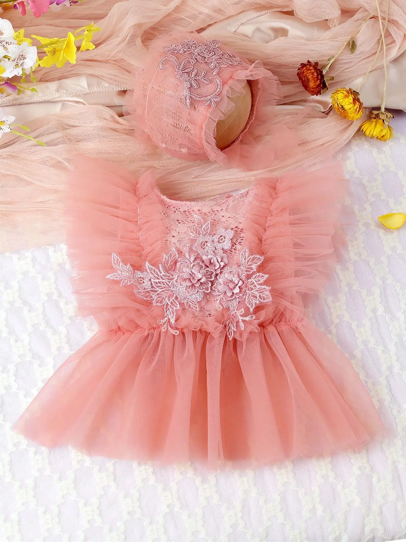 Newborn baby girl in a stylish pink lace floral mesh romper set, a cute infant outfit.