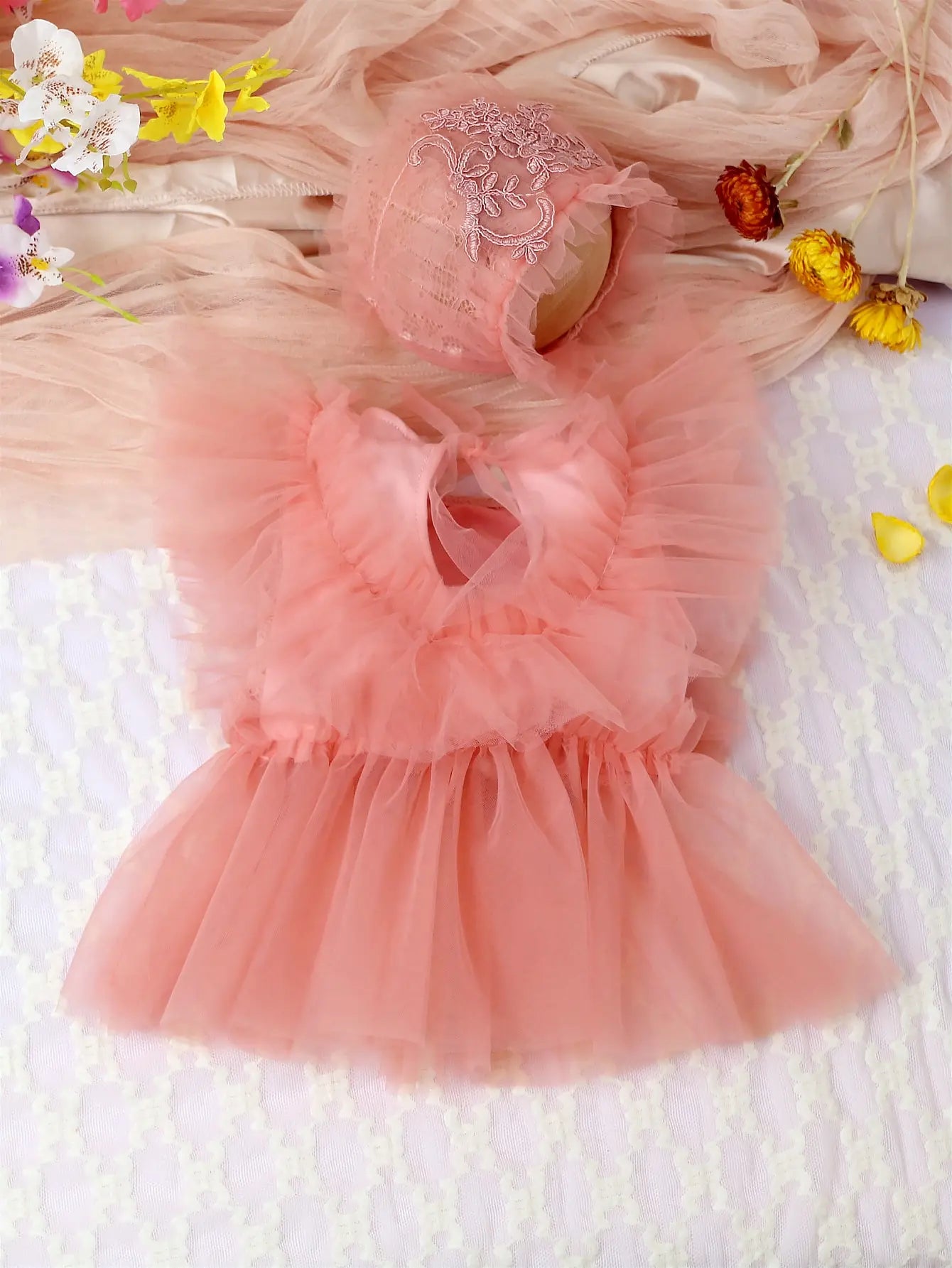 Detail shot of the comfortable fabric and cute design of the baby girl's floral lace mesh romper.