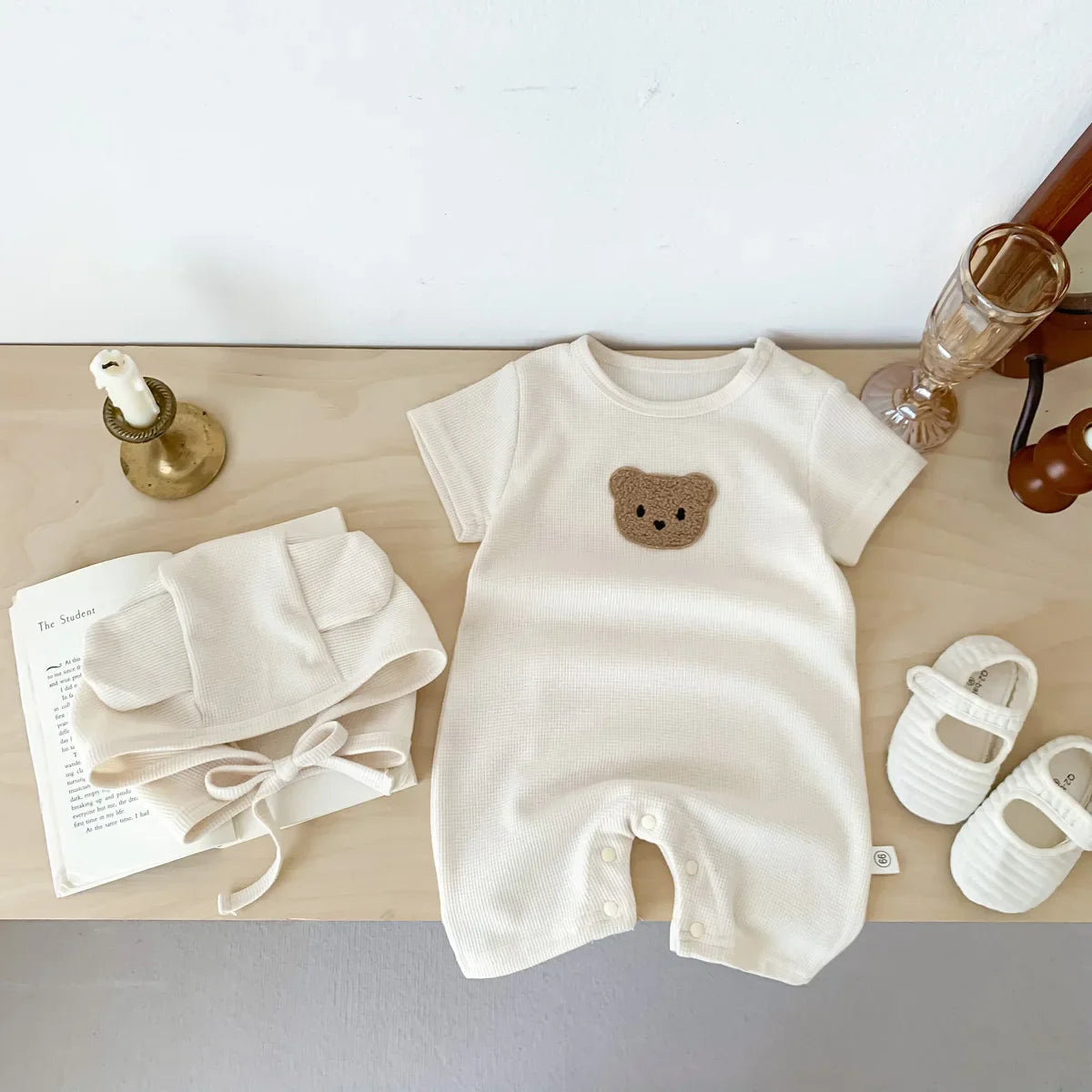 Bear themed newborn romper with convenient snap closures, easy to wear infant clothing.
