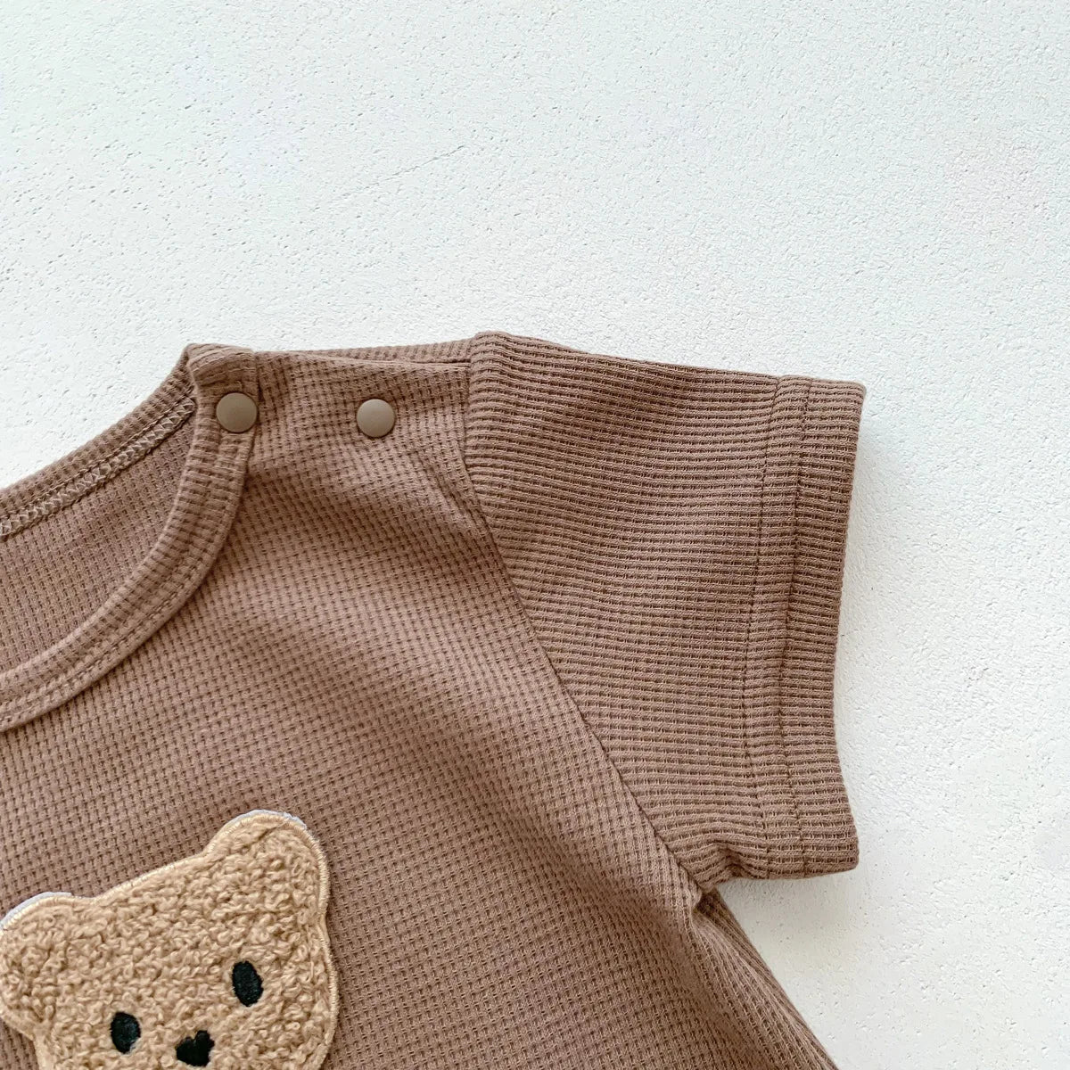 Child-safe cotton newborn bear romper, ensuring comfort for delicate baby skin.