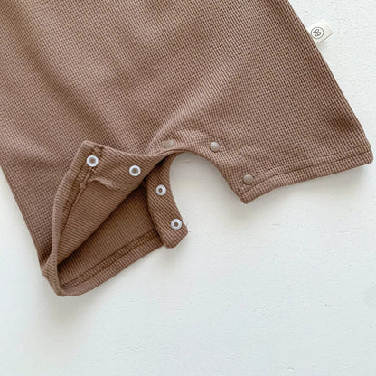 Model flat lay of the newborn bear romper set, highlighting its overall design.