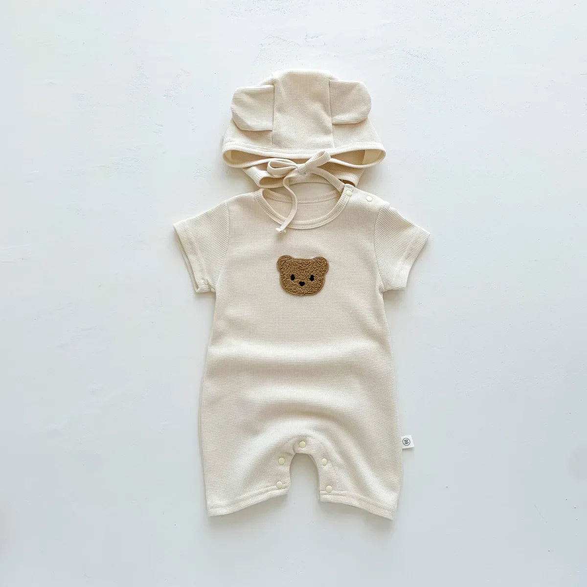 Newborn baby wearing a cozy bear romper, perfect for an infant gift, short sleeve.