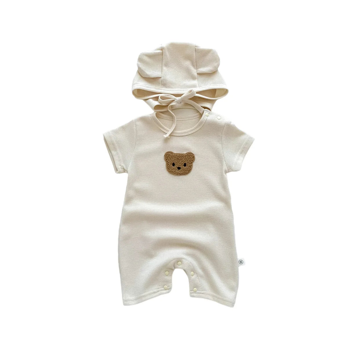 Infant laying comfortably in a short sleeve bear themed romper, baby fashion.