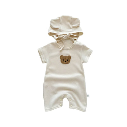 Infant laying comfortably in a short sleeve bear themed romper, baby fashion.