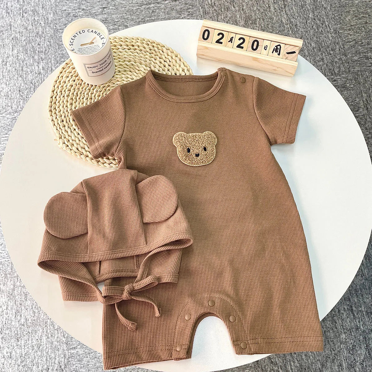 Newborn bear romper set folded neatly, showcasing the cotton fabric and design.
