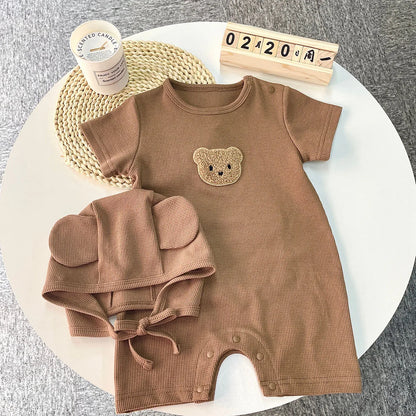 Newborn bear romper set folded neatly, showcasing the cotton fabric and design.
