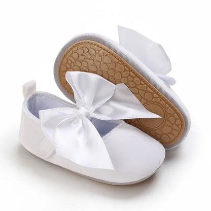 Close-up of a pink baby girl flat shoe bow detail, soft anti-slip sole, first walker comfortable
