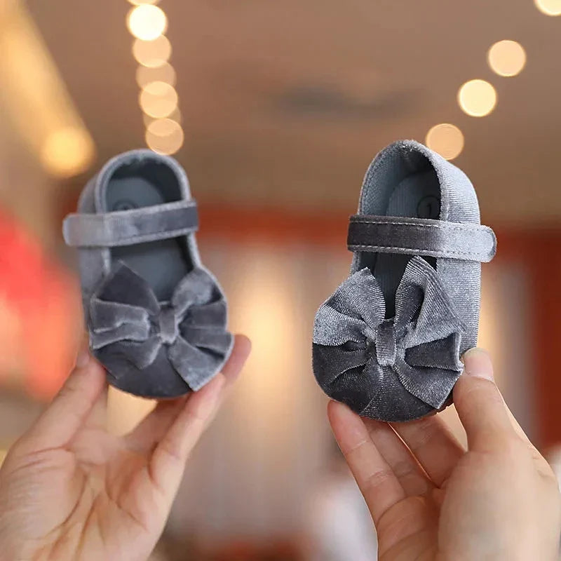 Cute blue baby girl flat shoes with a decorative bow, ideal for infant first steps, soft sole