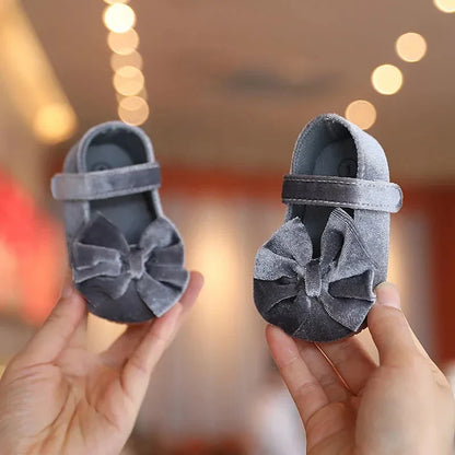 Cute blue baby girl flat shoes with a decorative bow, ideal for infant first steps, soft sole