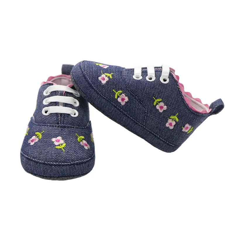 A pair of adorable pink lace floral first walker shoes for infant girls, featuring soft cotton and sweet design.